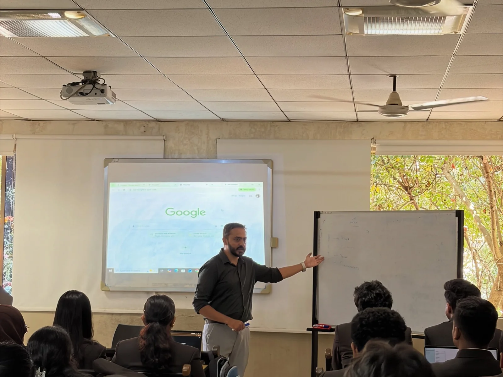An Upskill trainer explaining AI concepts to students at CBALC.